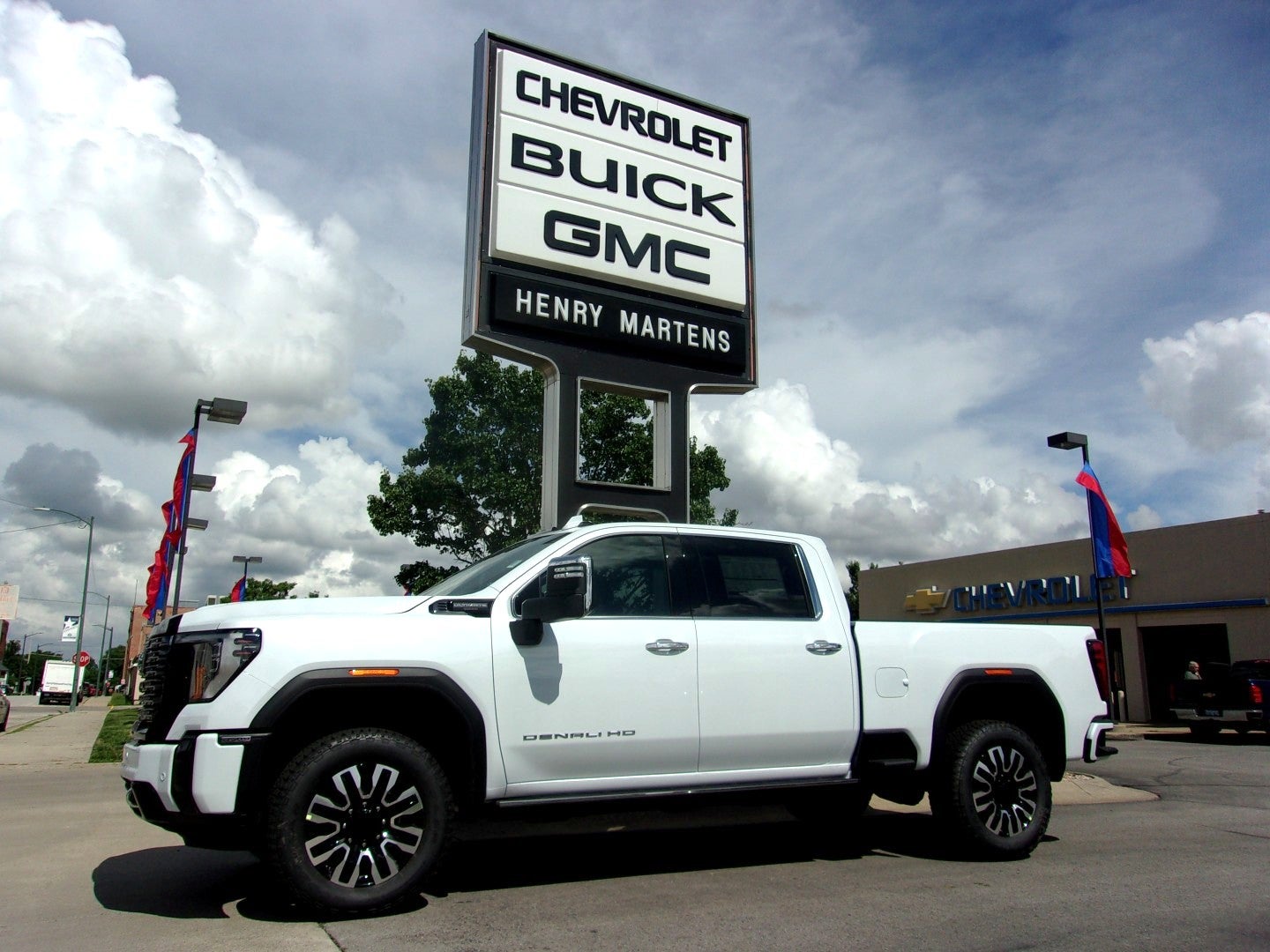 2026 GMC Sierra 2500 HD Denali Ultimate in Glacier White Tricoat — front three-quarter view