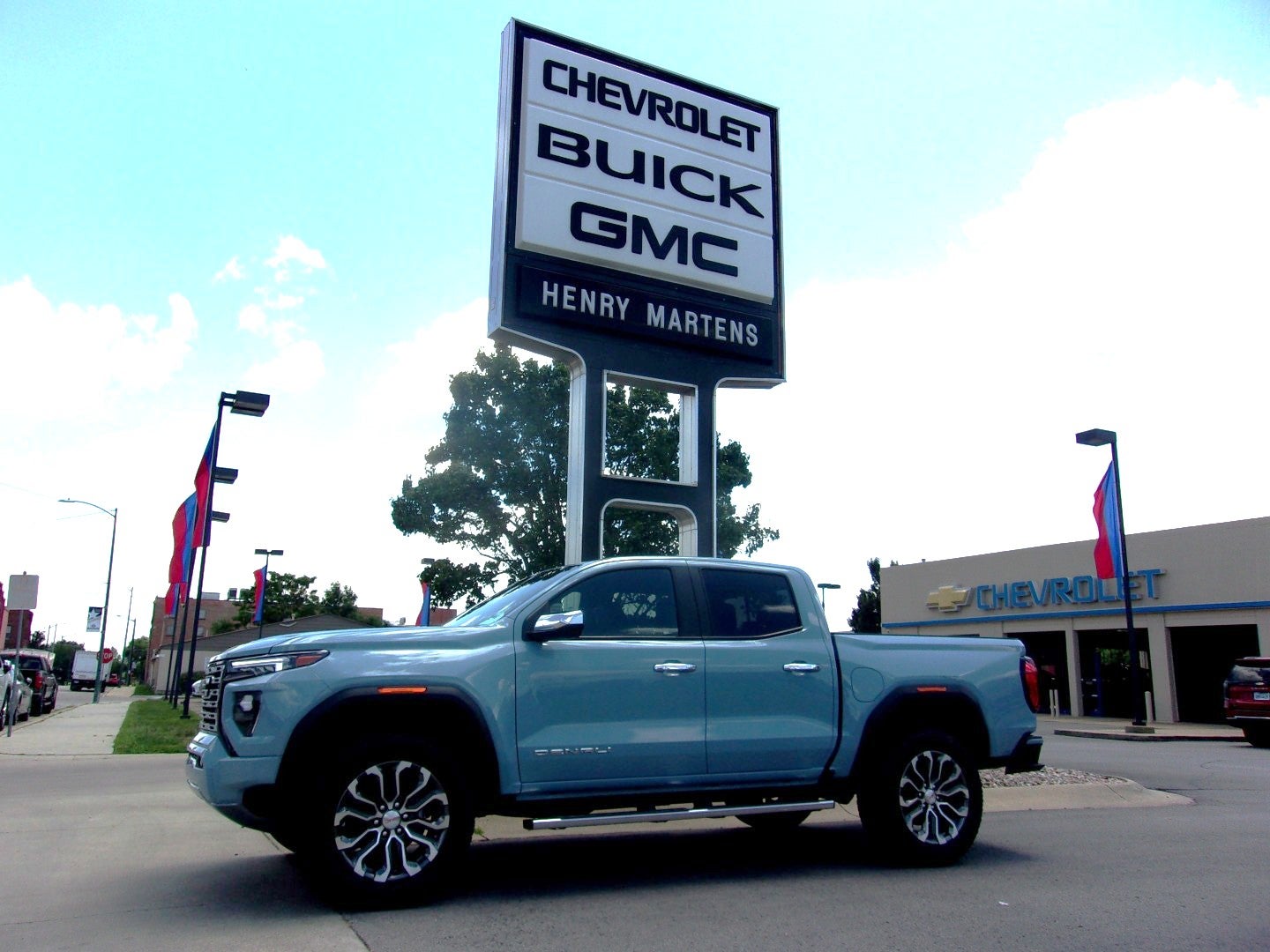 2026 GMC Canyon Denali in Glacier Metallic — front three-quarter view