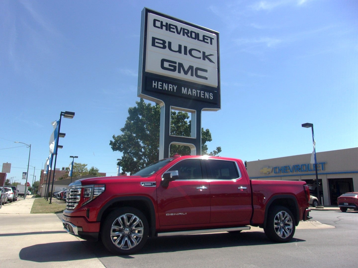 2024 GMC Sierra 1500 Denali in Volcanic Red Tintcoat — front three-quarter view