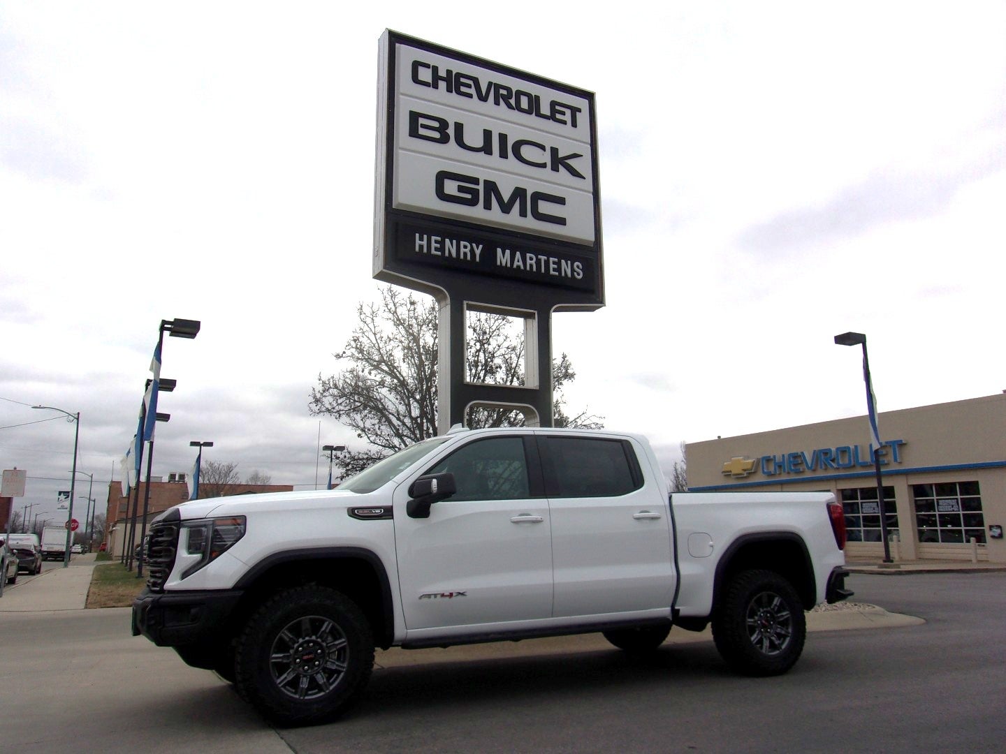 2026 GMC Sierra 1500 AT4X in Summit White — front three-quarter view