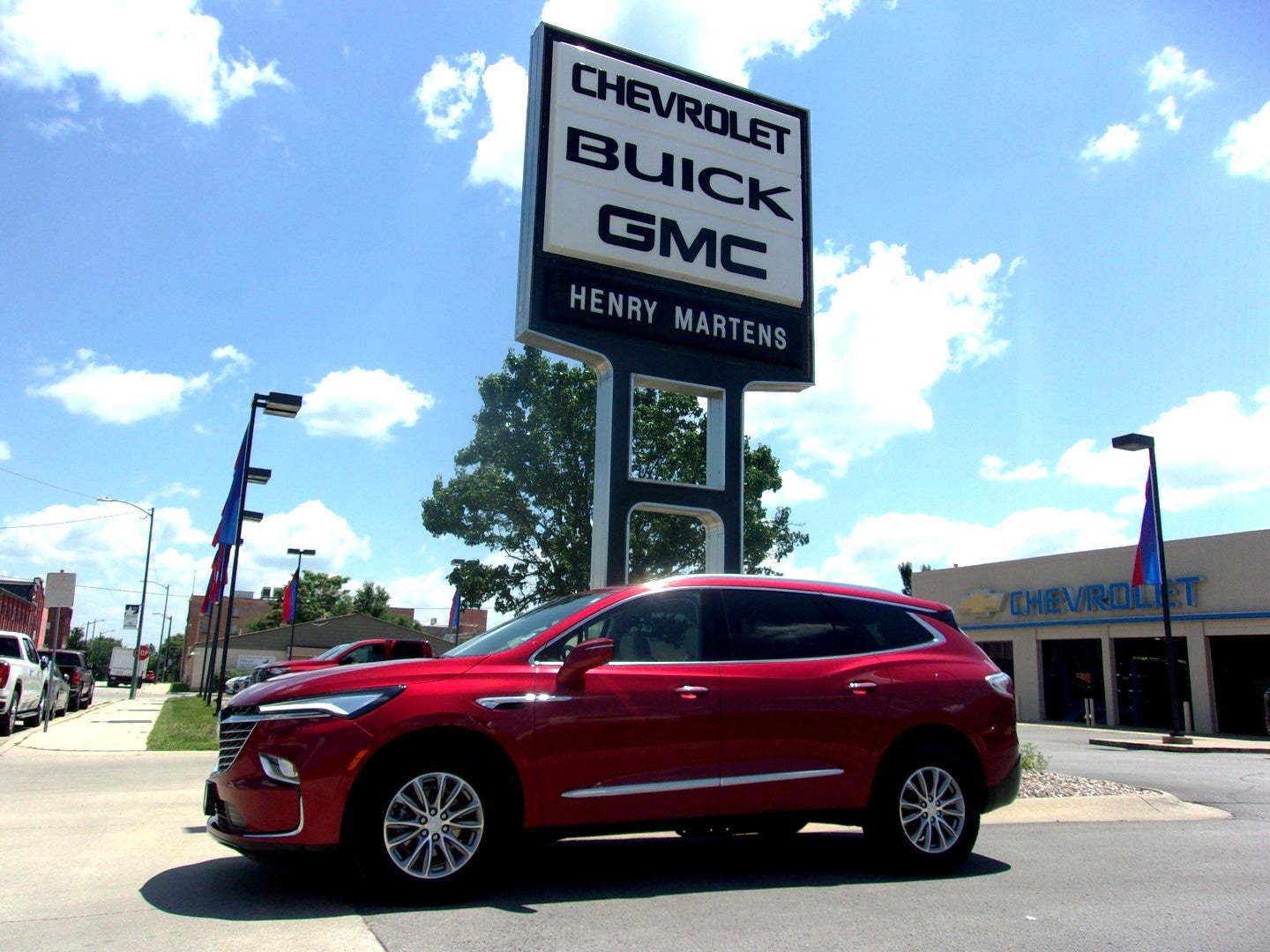 2022 Buick Enclave Essence in Cherry Red Tintcoat — front three-quarter view