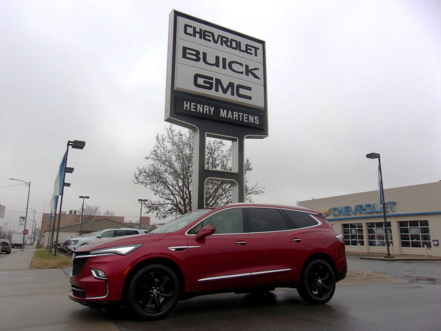 2023 Buick Enclave Essence in Cherry Red Tintcoat — front three-quarter view