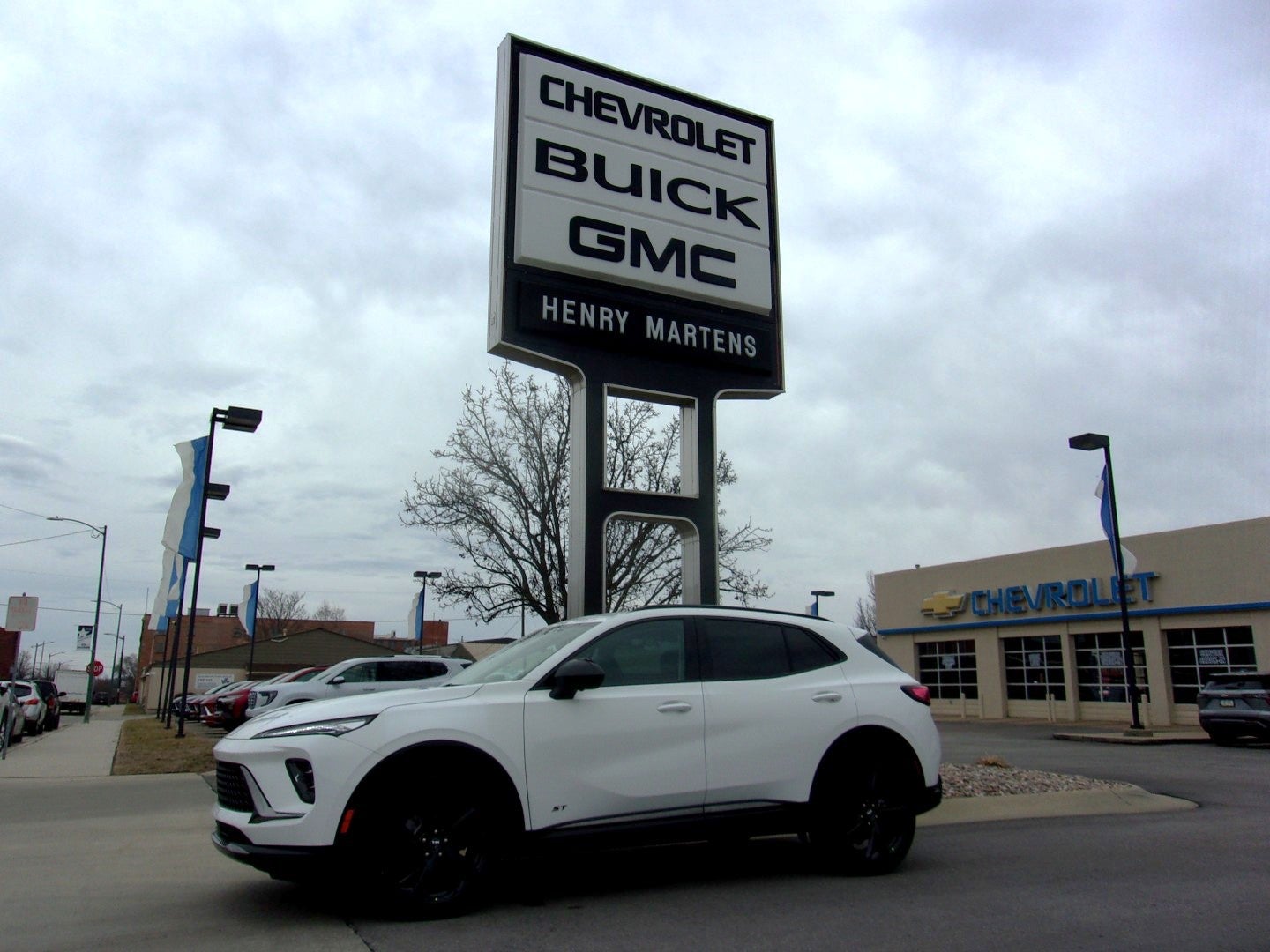 2026 Buick Envision Sport Touring in Summit White — front three-quarter view