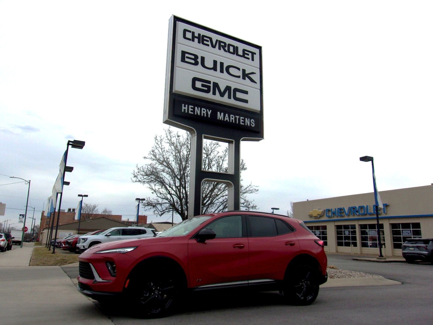 2026 Buick Envision Sport Touring in Brilliant Red — front three-quarter view